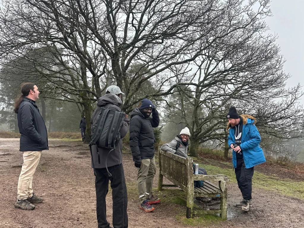 MPC-members-gathered-around-a-bench-chatting-and-enjoying-the-outdoors-near-a-bare-tree-on-a-misty-day