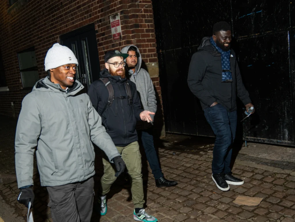 A-group-of-four-people-walking-outdoors-during-season-2-session-4-of-MPC