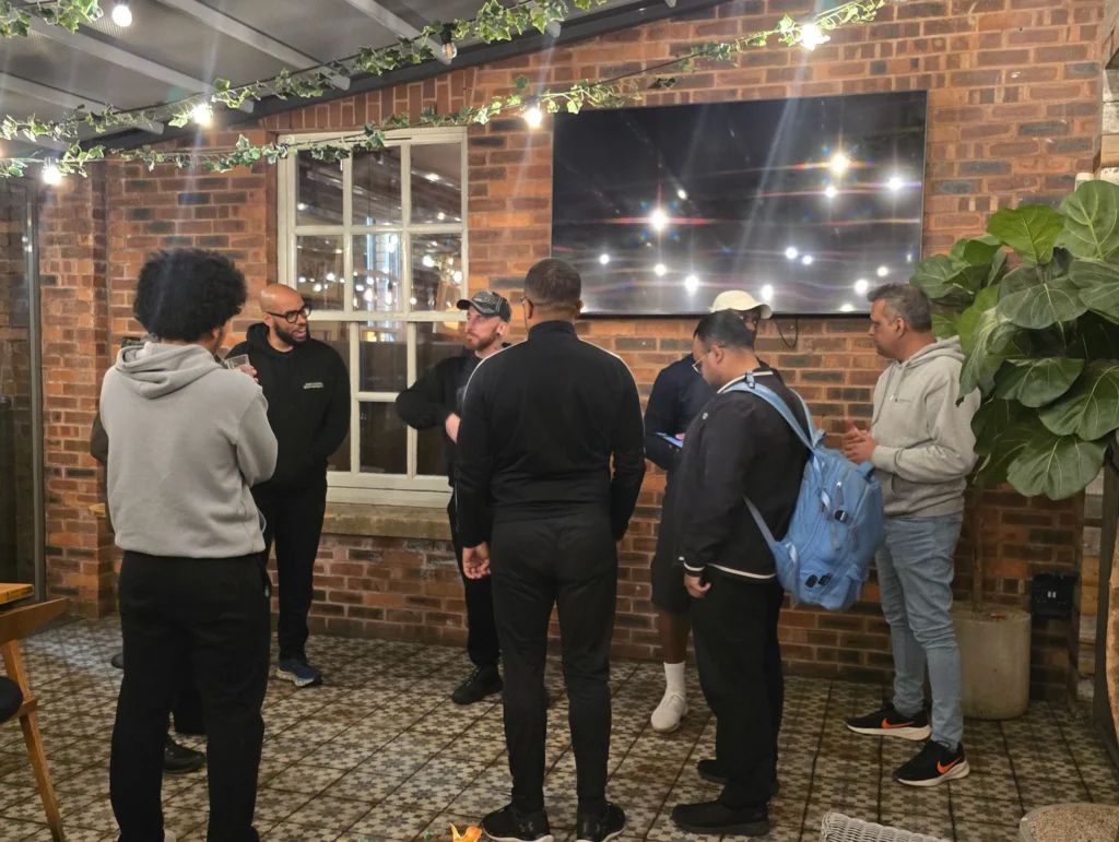 A-group-of-people-engaged-in-conversation-at-a-networking-event-gathered-around-in-a-casual-setting