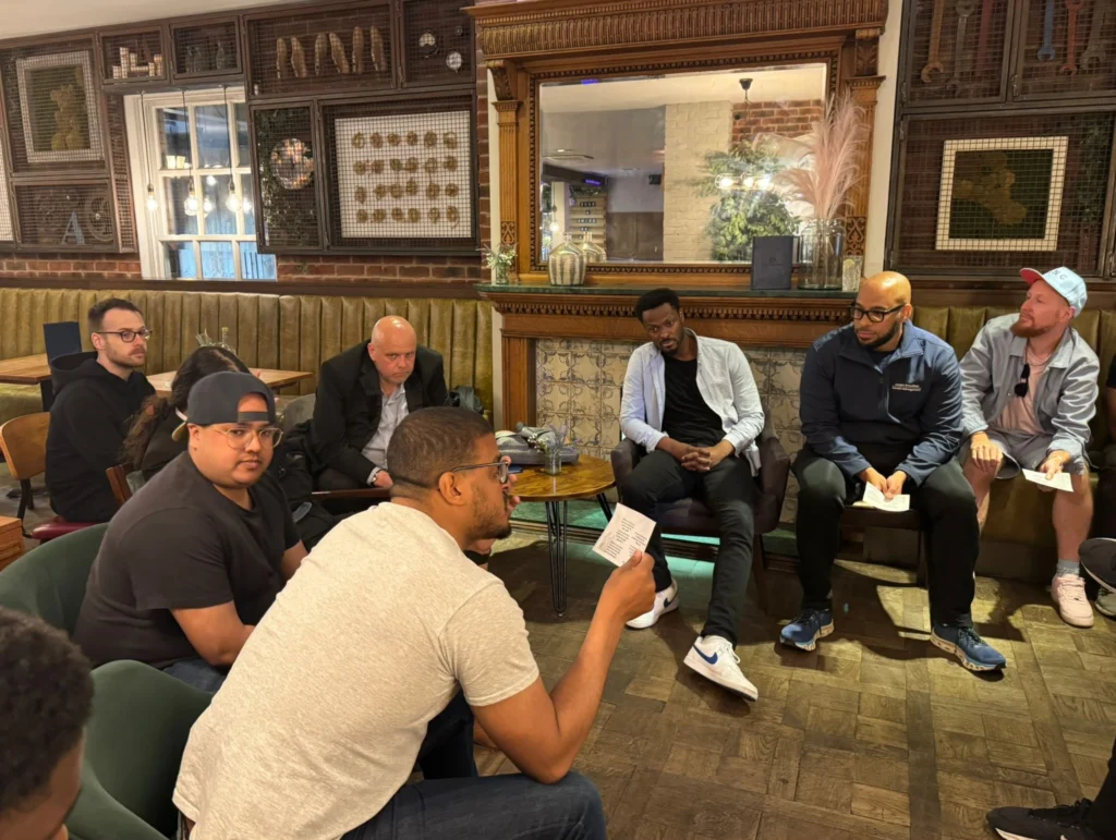 Group-discussion-at-Mens-Prosperity-Club-event-with-individuals-seated-and-engaging-in-conversation