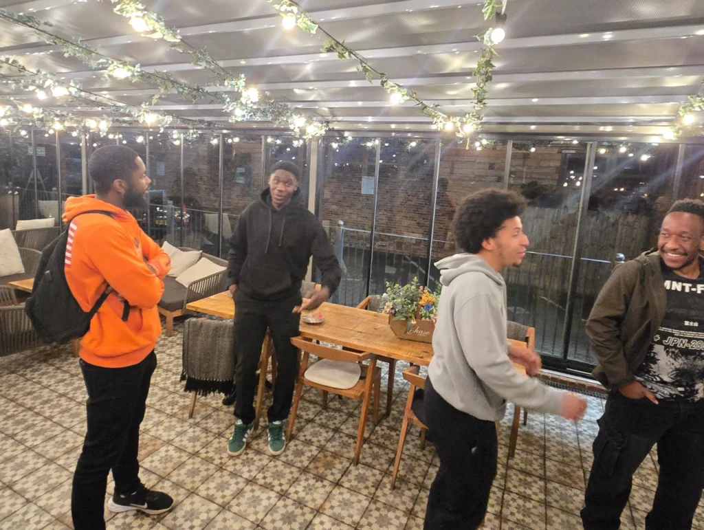 People-chatting-and-laughing-during-a-networking-event-with-one-person-wearing-an-orange-hoodie