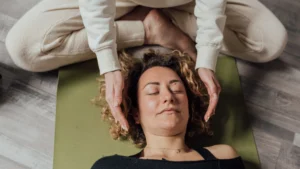 Spiritual-Healing-through-Reiki-Image-of-a-person-receiving-Reiki-or-energy-healing-with-hands-above-their-head
