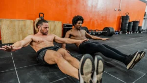 Two-men-performing-exercise-routine-in-gym