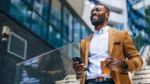 smiling-man-with-coffee-experiencing-positive-emotions-in-city
