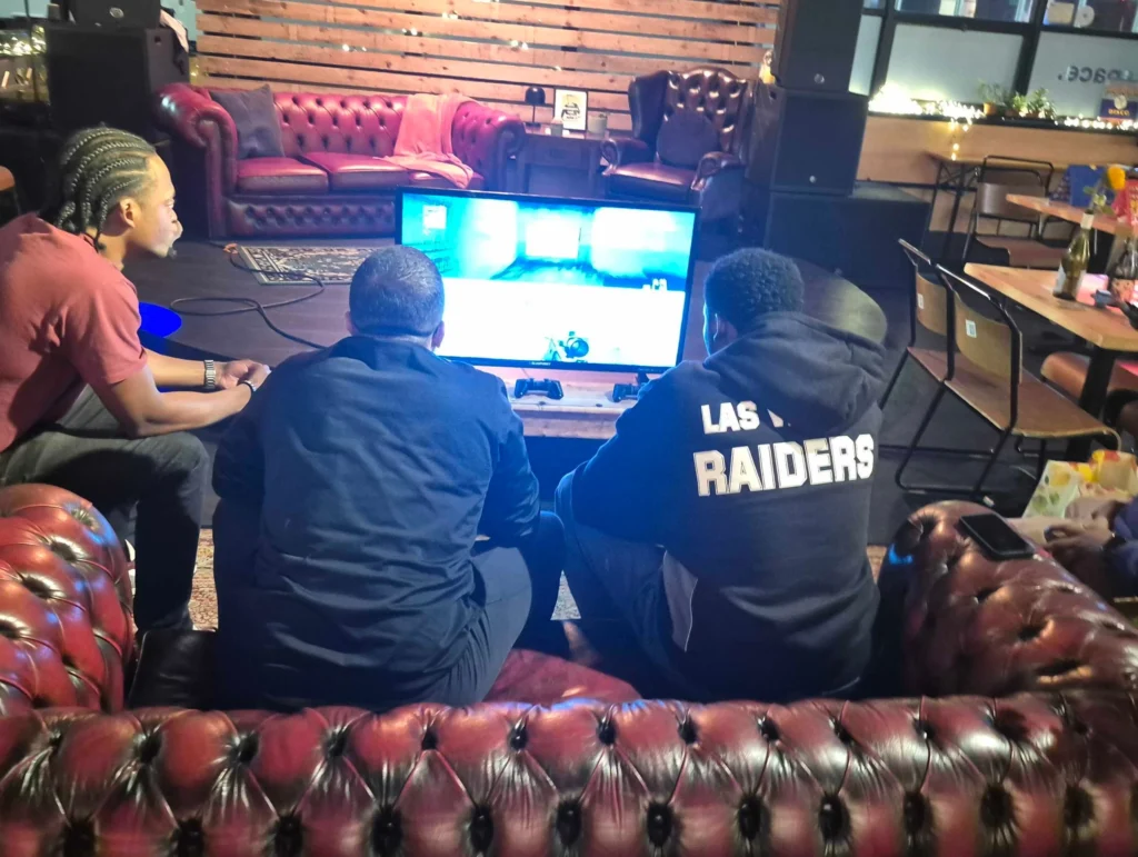 Attendees-focused-on-a-gaming-console-during-a-social-gathering-Games-Social-October-2025