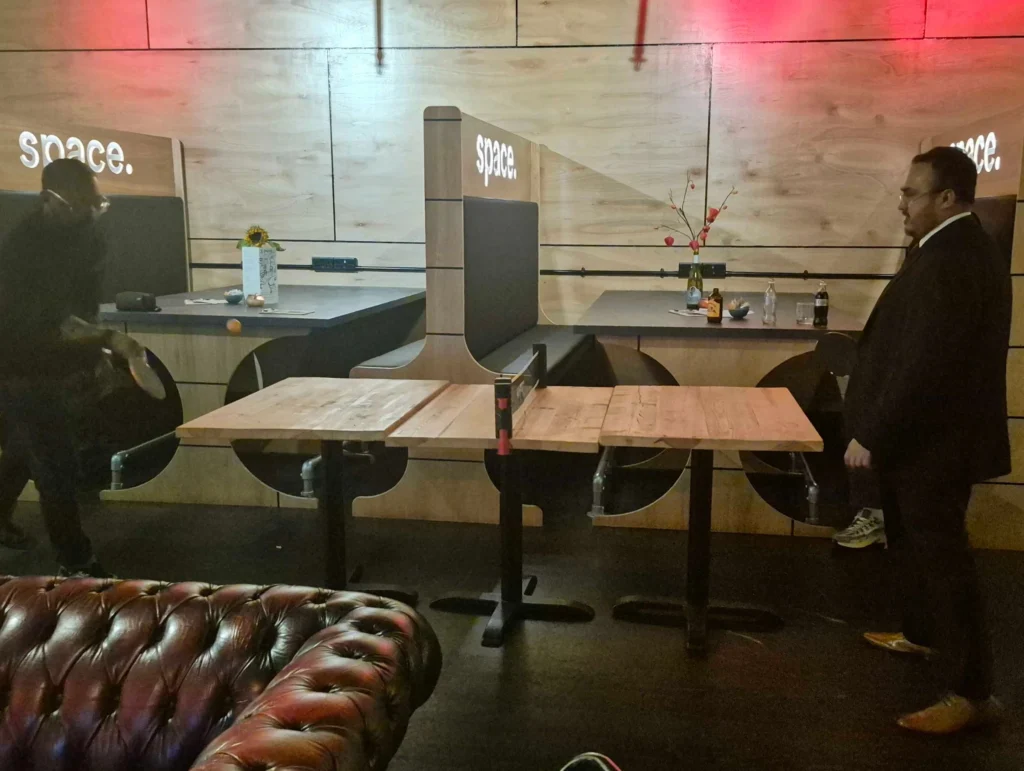 Individuals-setting-up-a-ping-pong-table-at-a-social-gathering-Games-Social-October-2025