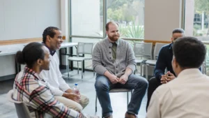 A-support-group-of-men-sitting-in-a-circle-discussing-health-and-the-benefits-of-a-Prostate-Diet