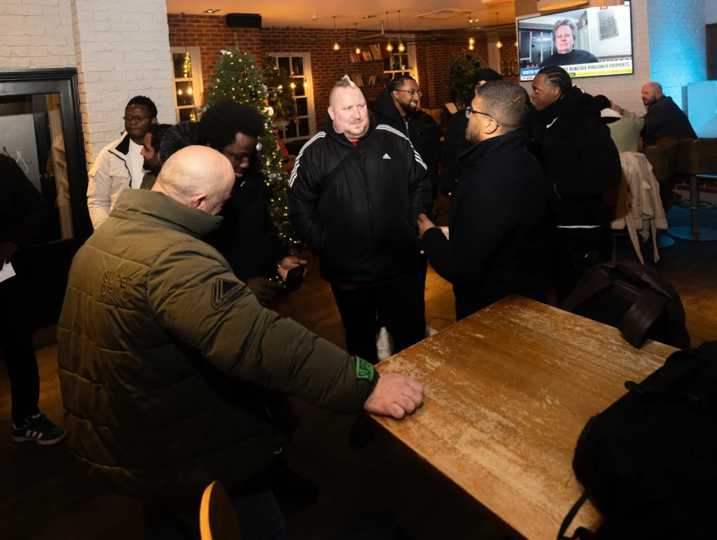Group-of-people-standing-together-at-restaurant-sharing-finance-topics