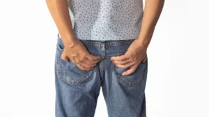 Man-holding-his-lower-back-representing-symptoms-related-to-prostate-issues