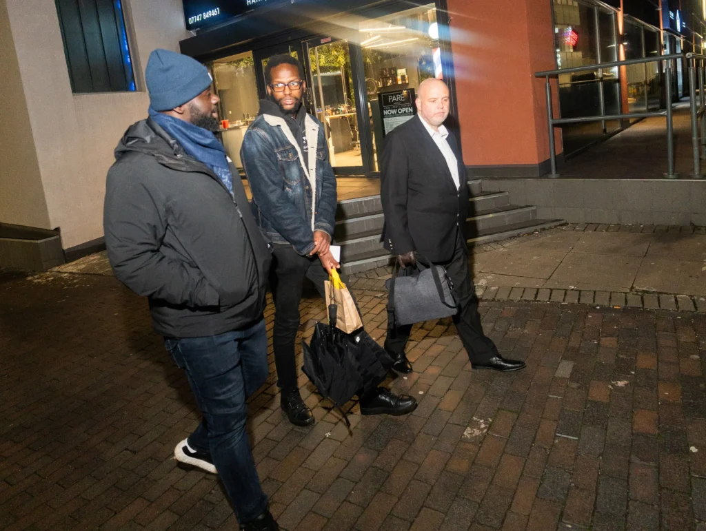 People-walking-together-on-a-city-street-at-night-engaged-in-faith-and-spirituality-topics