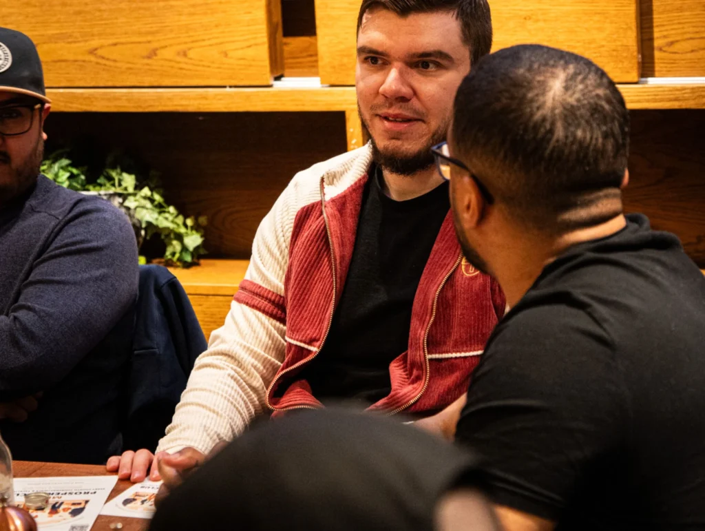 Two-people-having-a-conversation-at-table-during-health-and-fitness-meeting