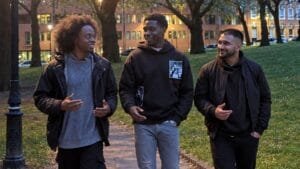 Men’s-Prosperity-Club-founder-and-two-fellow-participants-walking-and-chatting-on-a-park-path-at-dusk
