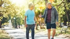Self-Reflection-through-conversation-as-two-men-walk-together-outdoors-sharing-experiences-and-building-connection-through-honest-discussion
